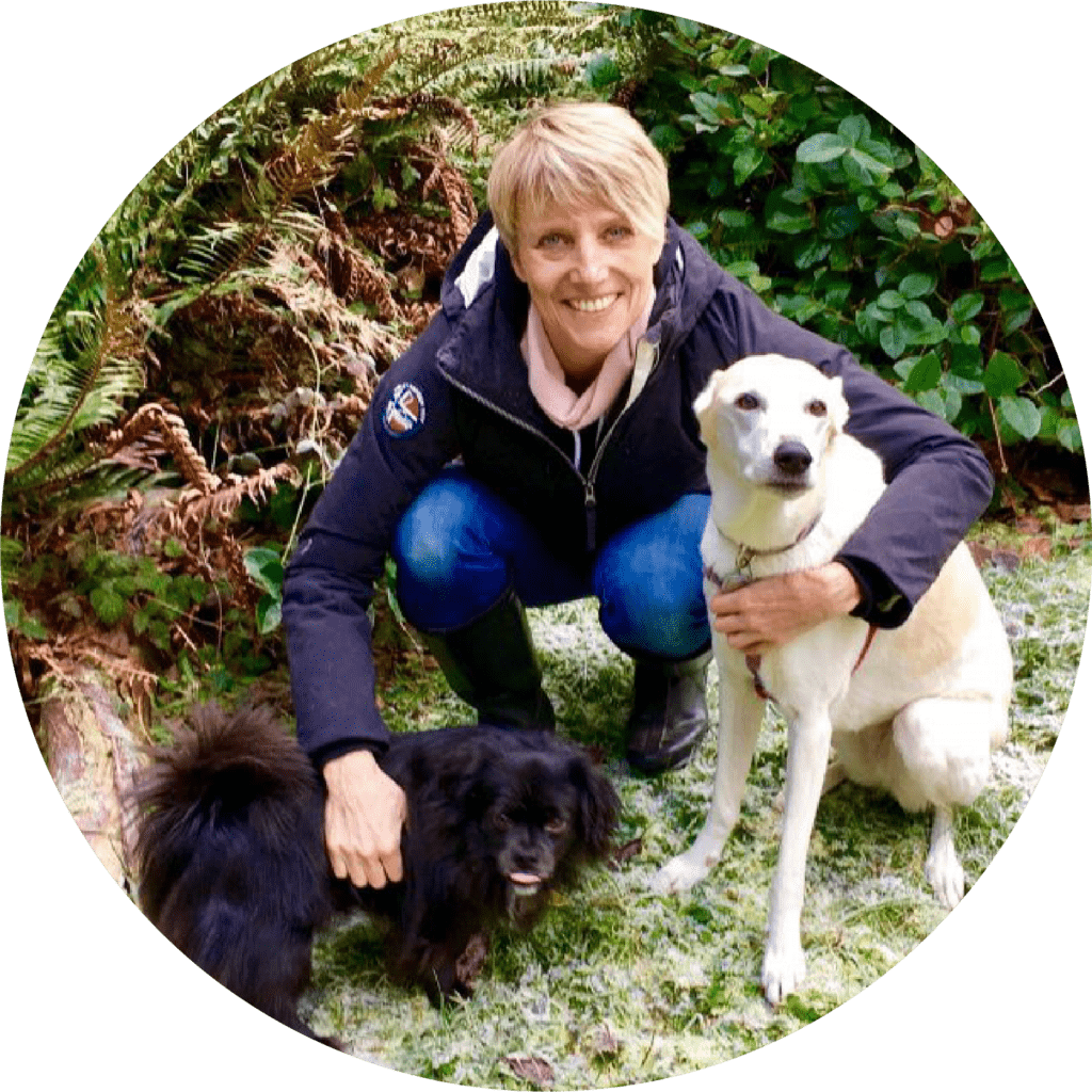 Sarah, a mentor at The Academy for Dog Trainers, poses with two dogs