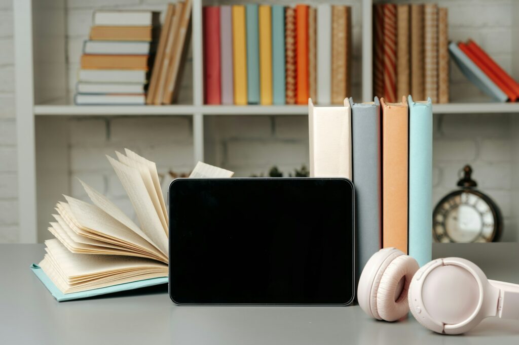 Digital tablet with stacked books in library